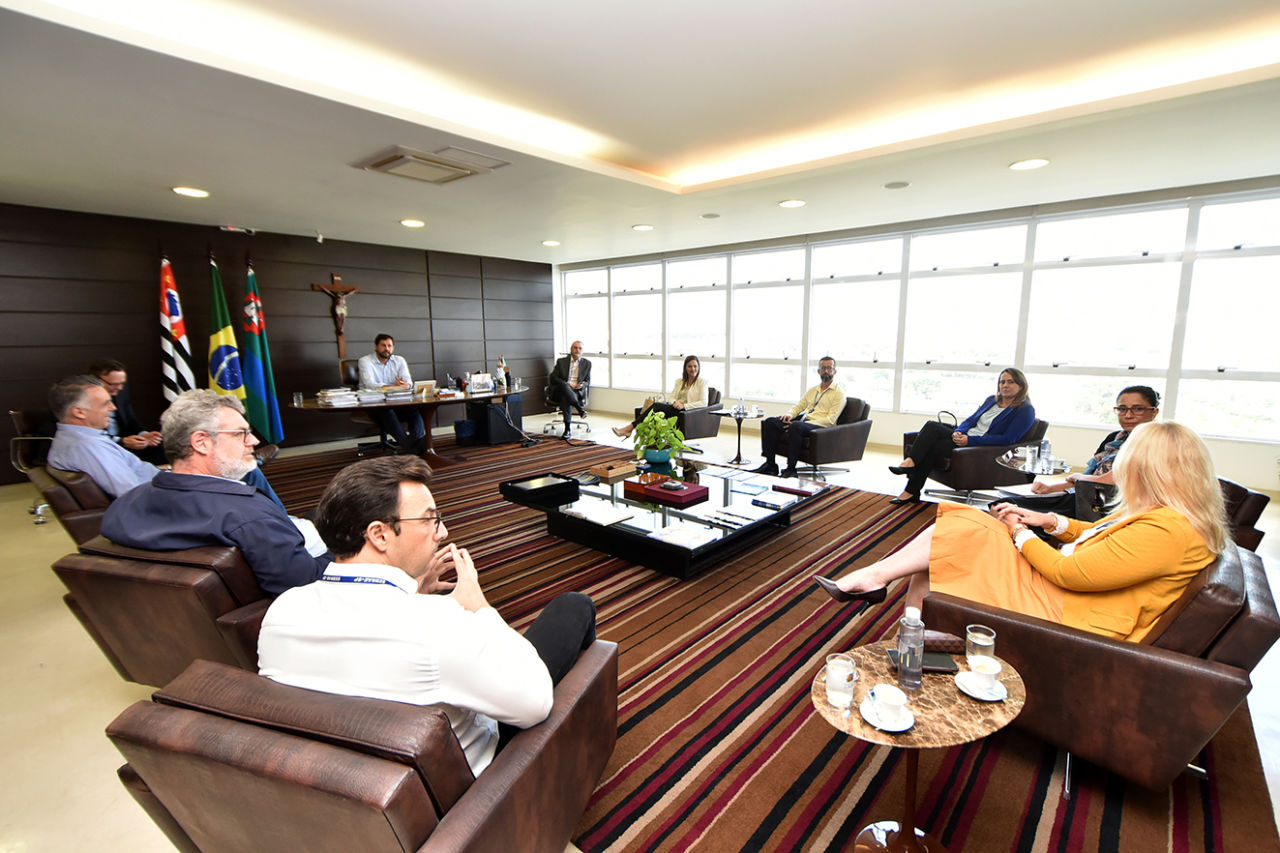 Imagem destaca o espaço do gabinete, com todos os participantes da reunião sentados; ao fundo, em sua mesa, está o prefeito de Jundiaí, Luiz Fernando Machado